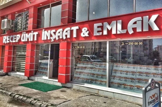 The red-fronted exterior of the Recep Ümit İnşaat Emlak office